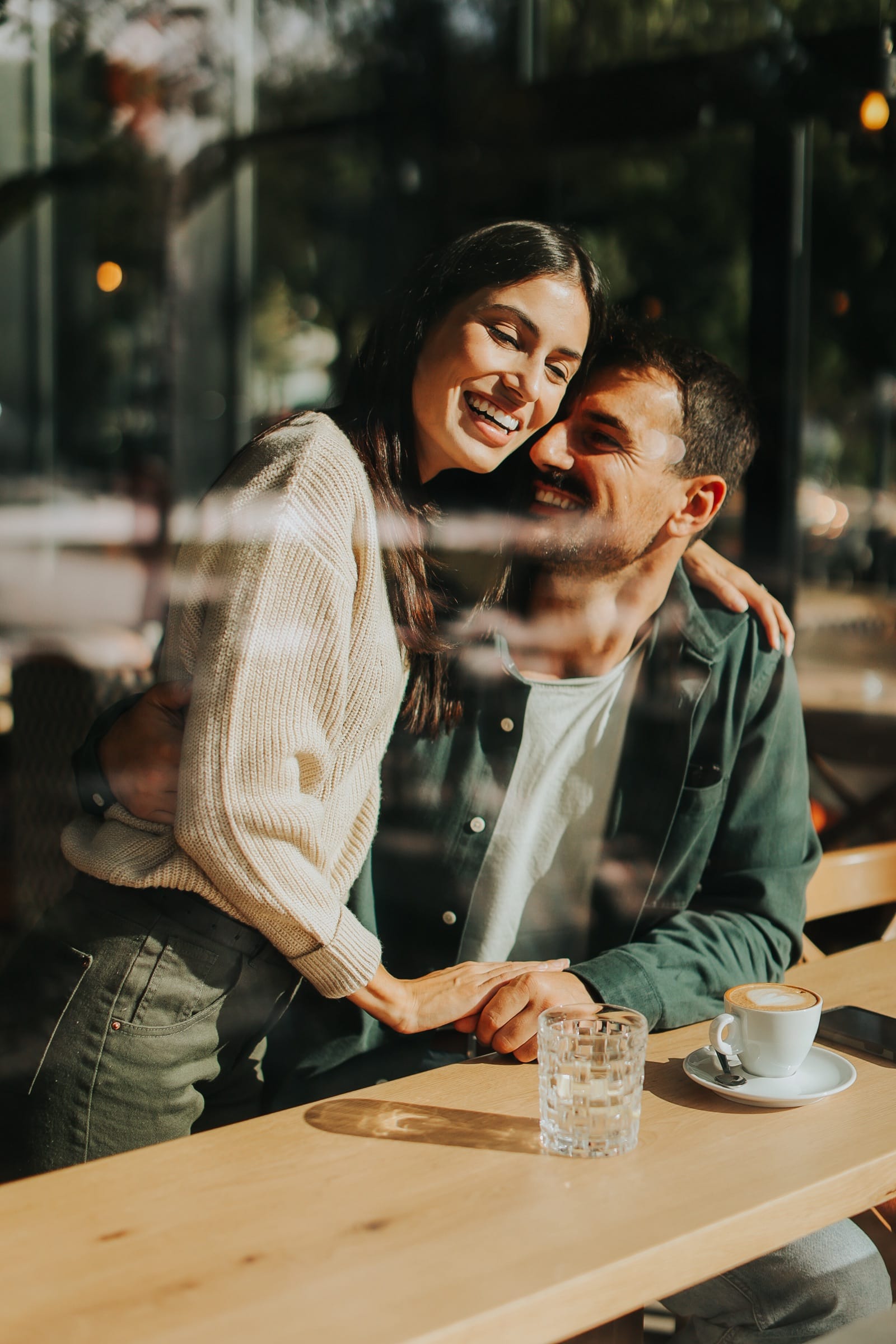 A couple sharing a warm moment in a cafe